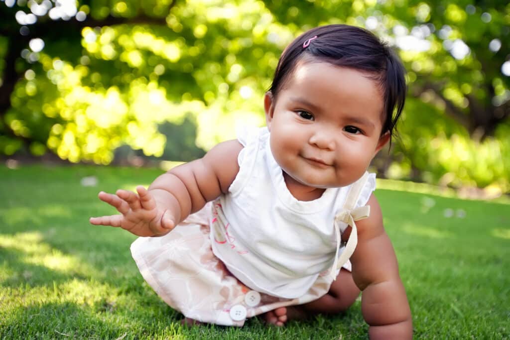 Infant crawling in the grass