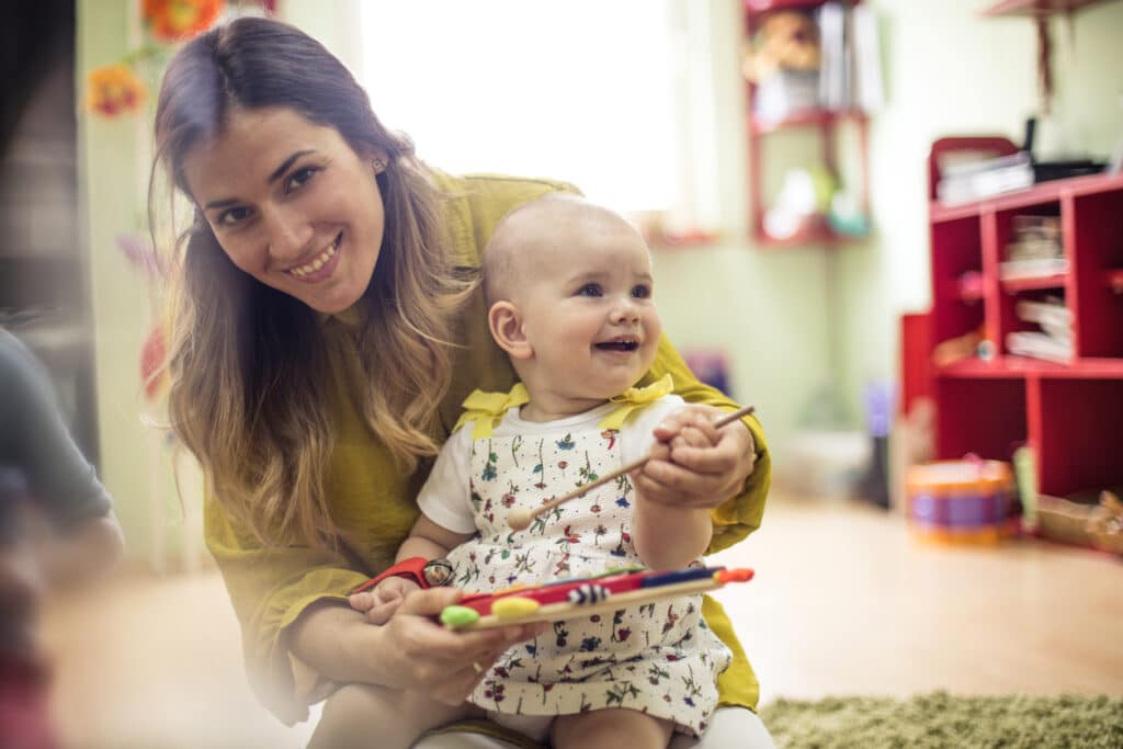 teacher and an infant in daycare