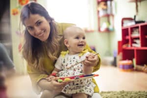teacher and an infant in daycare